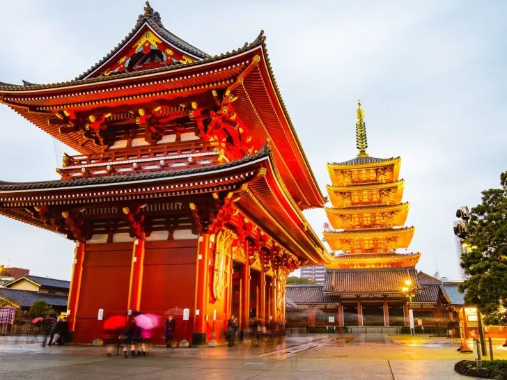Large red Shinto shrine with a small group by the entrance