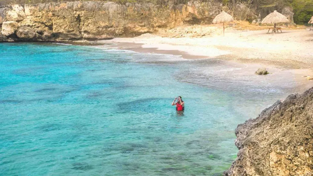 girl snorkeling in curacao along beach