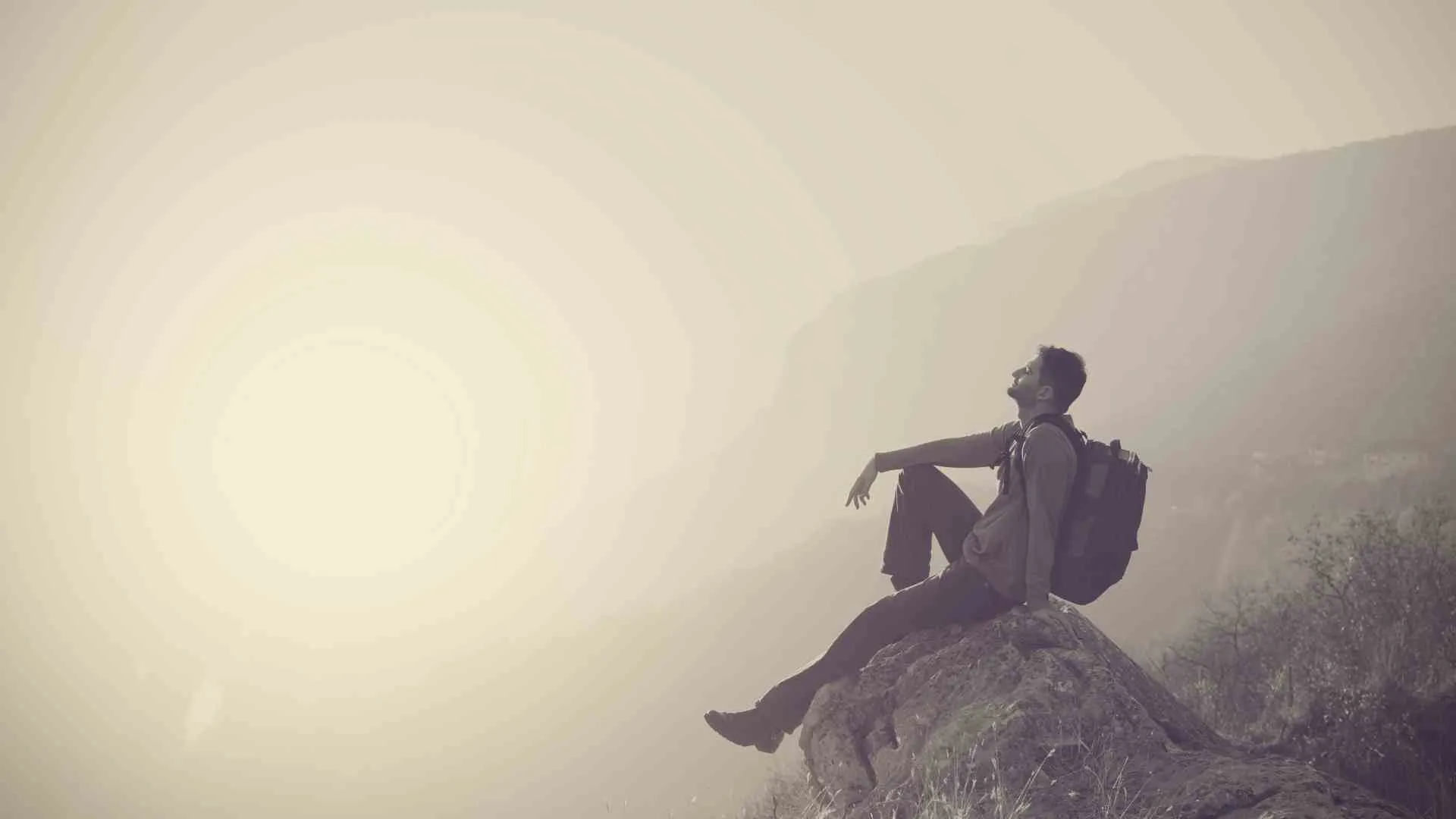 mindful travel (1) guy mindful sitting on a rock